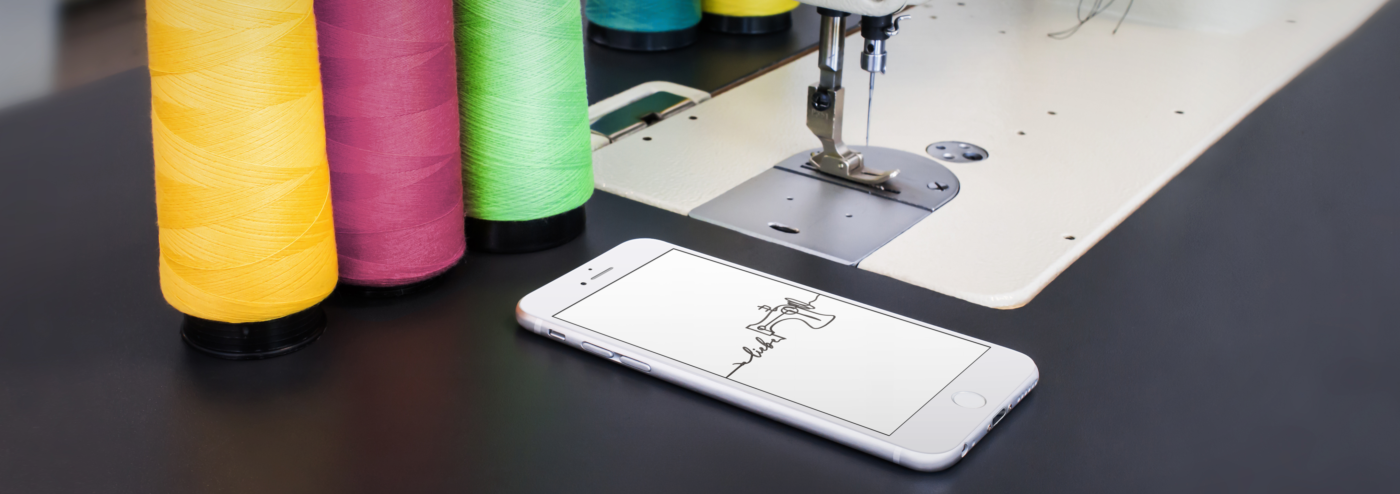 mockup of an iphone 6 lying next to a sewing machine a4649